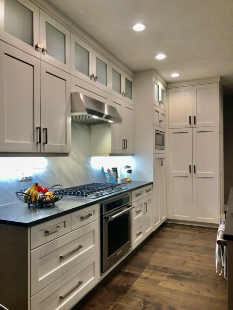 Custom maple cabinetry with granite island installed in a West Jordan kitchen